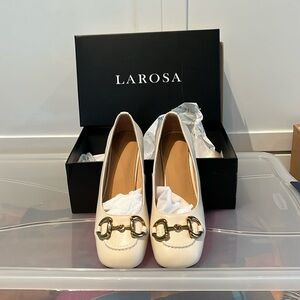 Larosa cream pumps. Gold buckle detail. 2” heal
